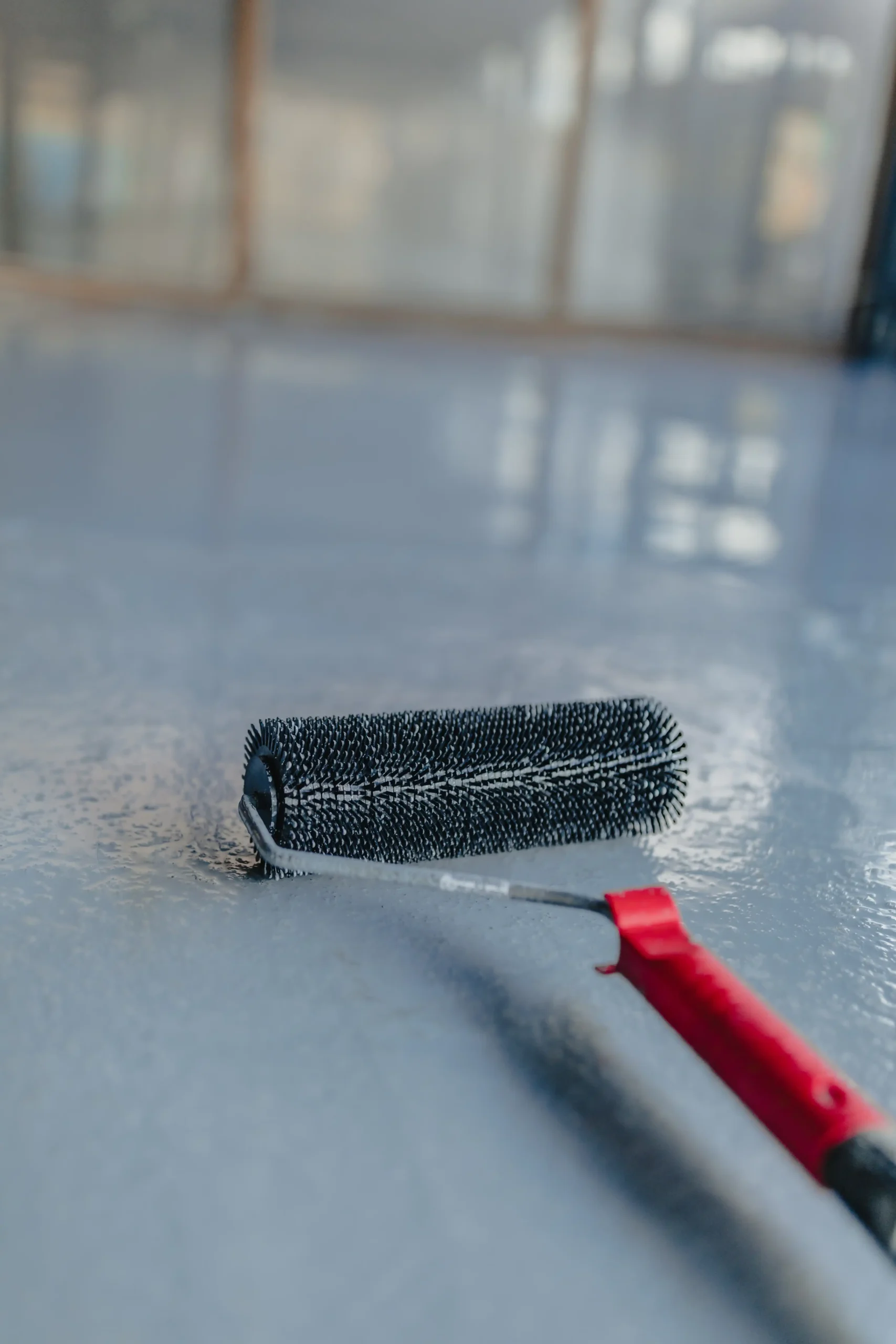 new-epoxy-flooring-roller-on-gray-concrete-surface-2026-03-25-06-33-55-utc